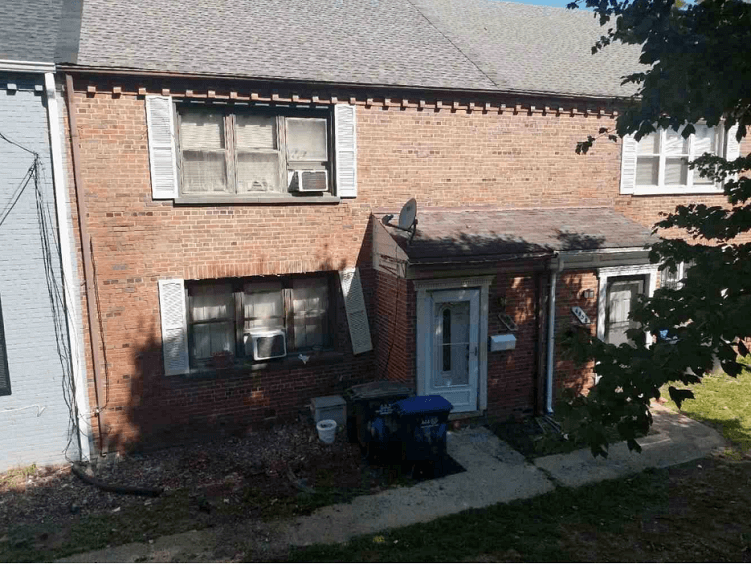 A view of the backyard of the brown colored house